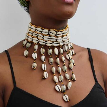 The KAMEGA Cowrie Leather Choker Necklace is a bold yet elegant accessory that brings African tradition to modern fashion. Handmade in Kenya, this choker features authentic cowrie shells sewn securely onto high-quality leather. Its simple tie back string closure and 10-inch length give it a snug, stylish fit—perfect for layering or wearing on its own. Shipping: • Fast international delivery via DHL Express (3–5 business days) • Shipping fee applies to the first item only – all additional items ship FREE