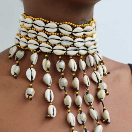 The KAMEGA Cowrie Leather Choker Necklace is a bold yet elegant accessory that brings African tradition to modern fashion. Handmade in Kenya, this choker features authentic cowrie shells sewn securely onto high-quality leather. Its simple tie back string closure and 10-inch length give it a snug, stylish fit—perfect for layering or wearing on its own. Shipping: • Fast international delivery via DHL Express (3–5 business days) • Shipping fee applies to the first item only – all additional items ship FREE