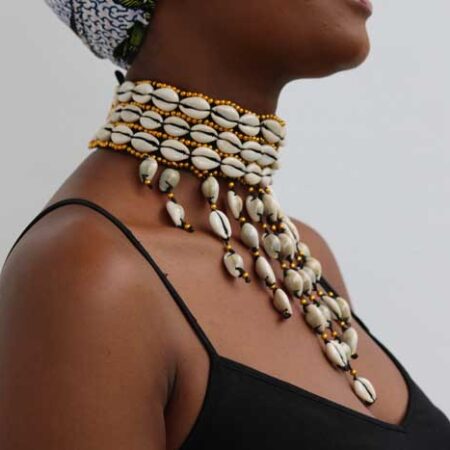 The KAMEGA Cowrie Leather Choker Necklace is a bold yet elegant accessory that brings African tradition to modern fashion. Handmade in Kenya, this choker features authentic cowrie shells sewn securely onto high-quality leather. Its simple tie back string closure and 10-inch length give it a snug, stylish fit—perfect for layering or wearing on its own. Shipping: • Fast international delivery via DHL Express (3–5 business days) • Shipping fee applies to the first item only – all additional items ship FREE