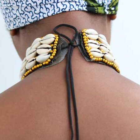 The KAMEGA Cowrie Leather Choker Necklace is a bold yet elegant accessory that brings African tradition to modern fashion. Handmade in Kenya, this choker features authentic cowrie shells sewn securely onto high-quality leather. Its simple tie back string closure and 10-inch length give it a snug, stylish fit—perfect for layering or wearing on its own. Shipping: • Fast international delivery via DHL Express (3–5 business days) • Shipping fee applies to the first item only – all additional items ship FREE