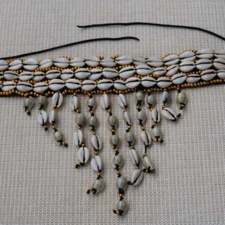The KAMEGA Cowrie Leather Choker Necklace is a bold yet elegant accessory that brings African tradition to modern fashion. Handmade in Kenya, this choker features authentic cowrie shells sewn securely onto high-quality leather. Its simple tie back string closure and 10-inch length give it a snug, stylish fit—perfect for layering or wearing on its own. Shipping: • Fast international delivery via DHL Express (3–5 business days) • Shipping fee applies to the first item only – all additional items ship FREE